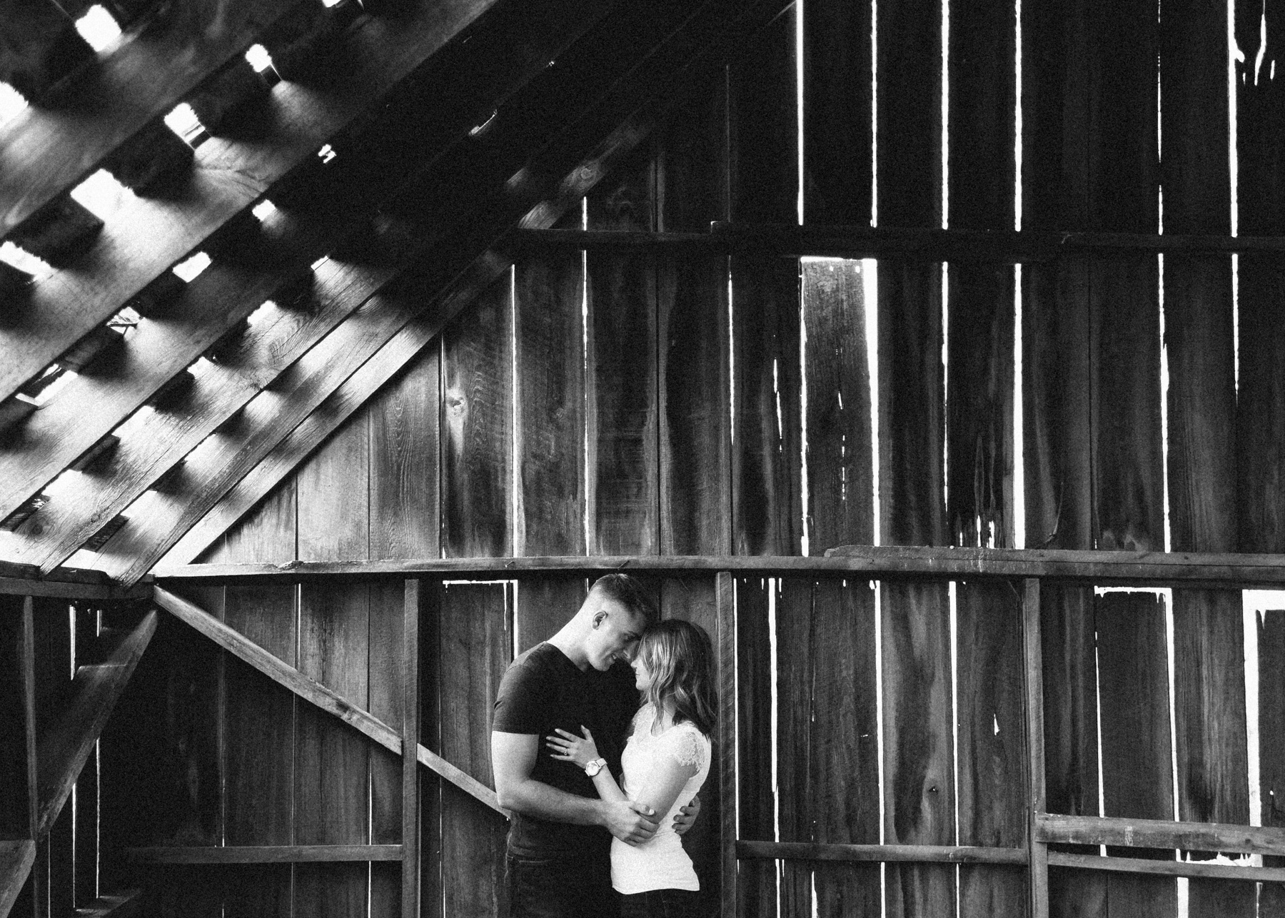 abby and zach in old rustic barn