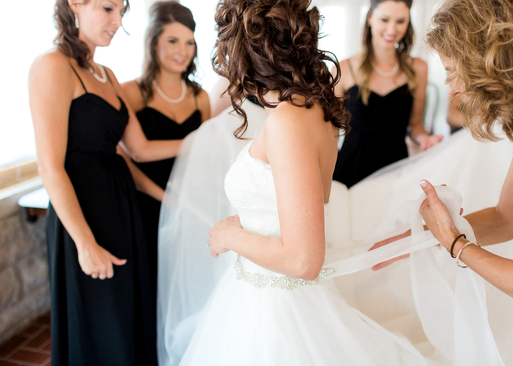 tying bow on wedding dress