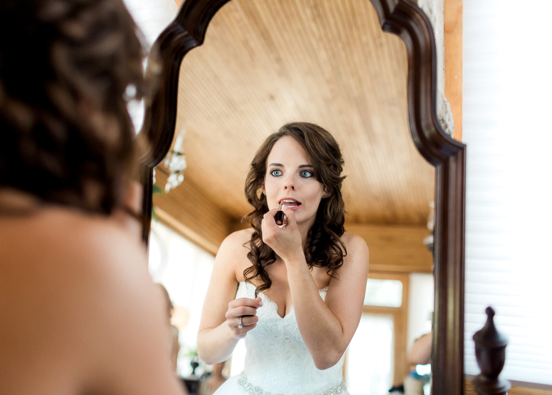 bride putting on lip stick