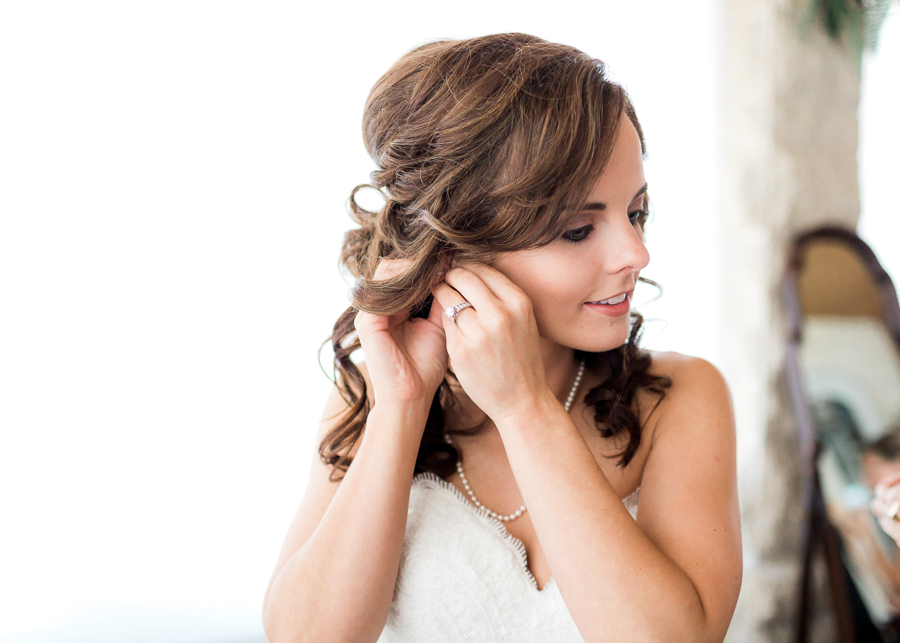 bride putting on earings