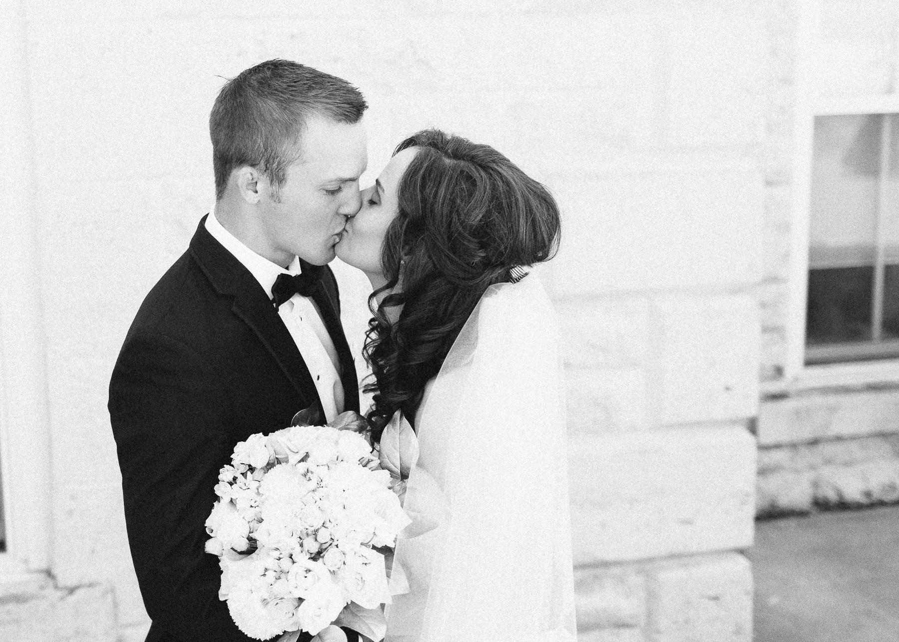 black and white bride and groom kissing