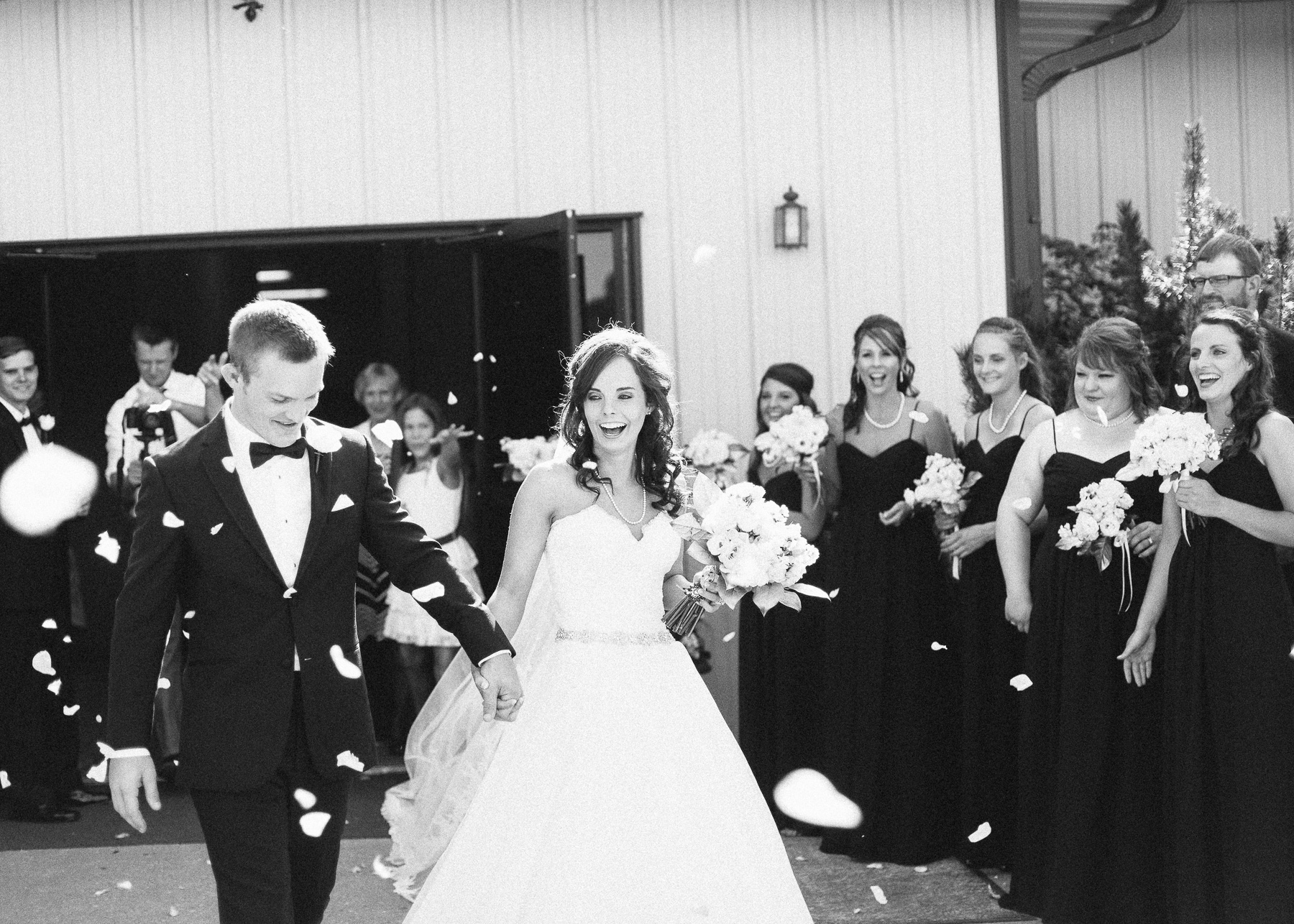 bride and groom exit with rose petals