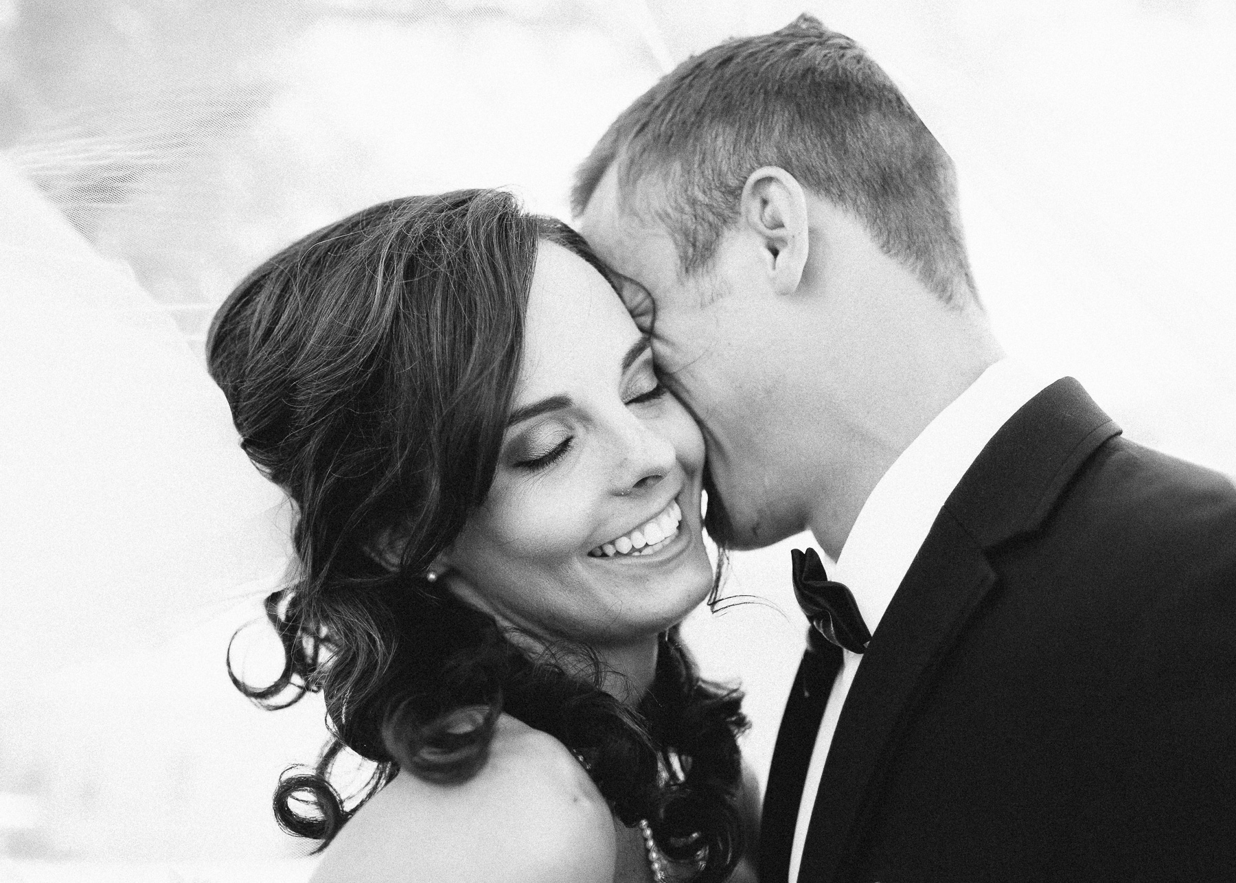 bride smiling underneath veil