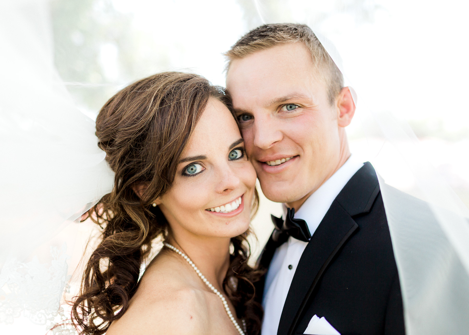 bride and groom looking at camera smiling