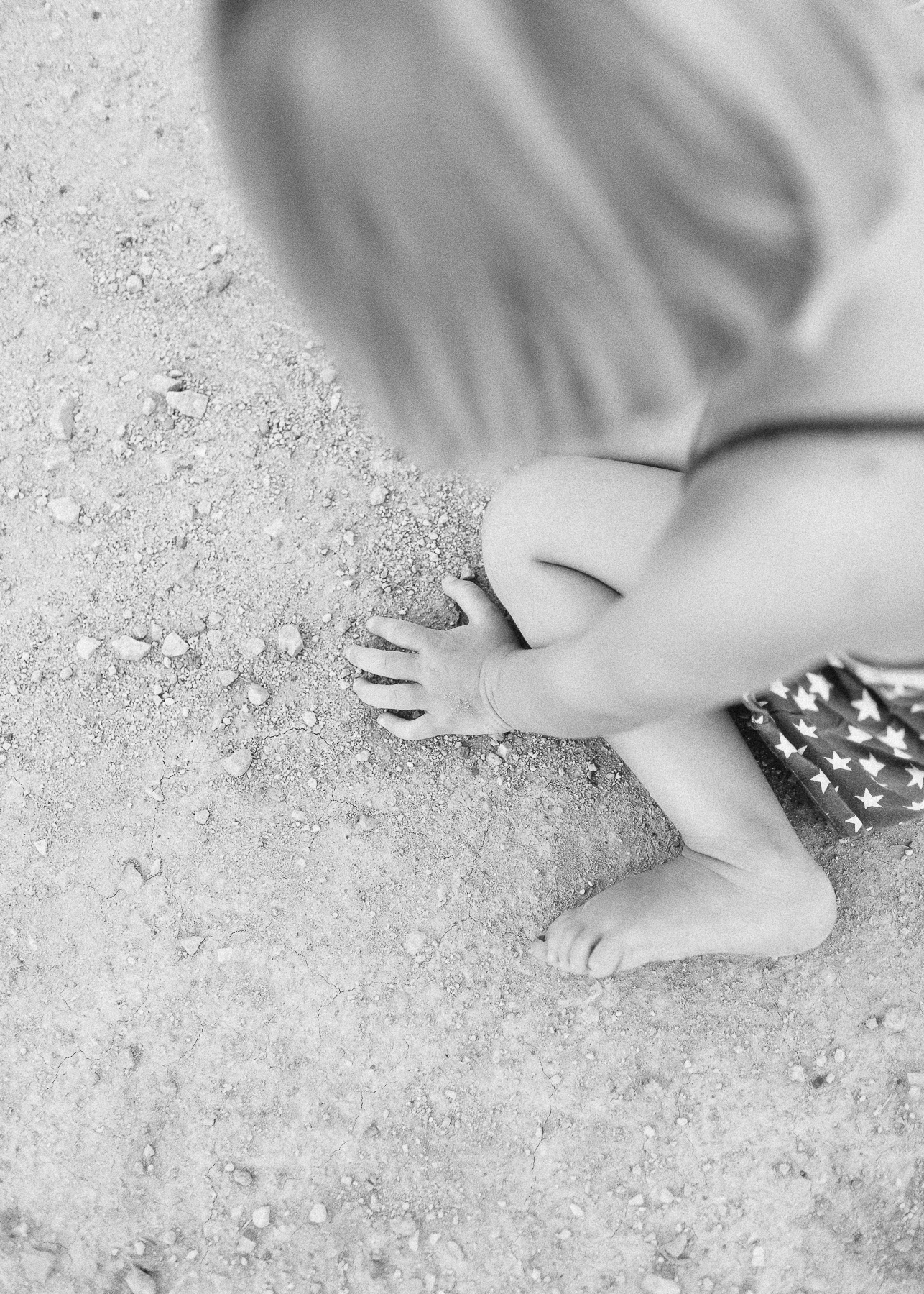 girls feet and hands in dirt