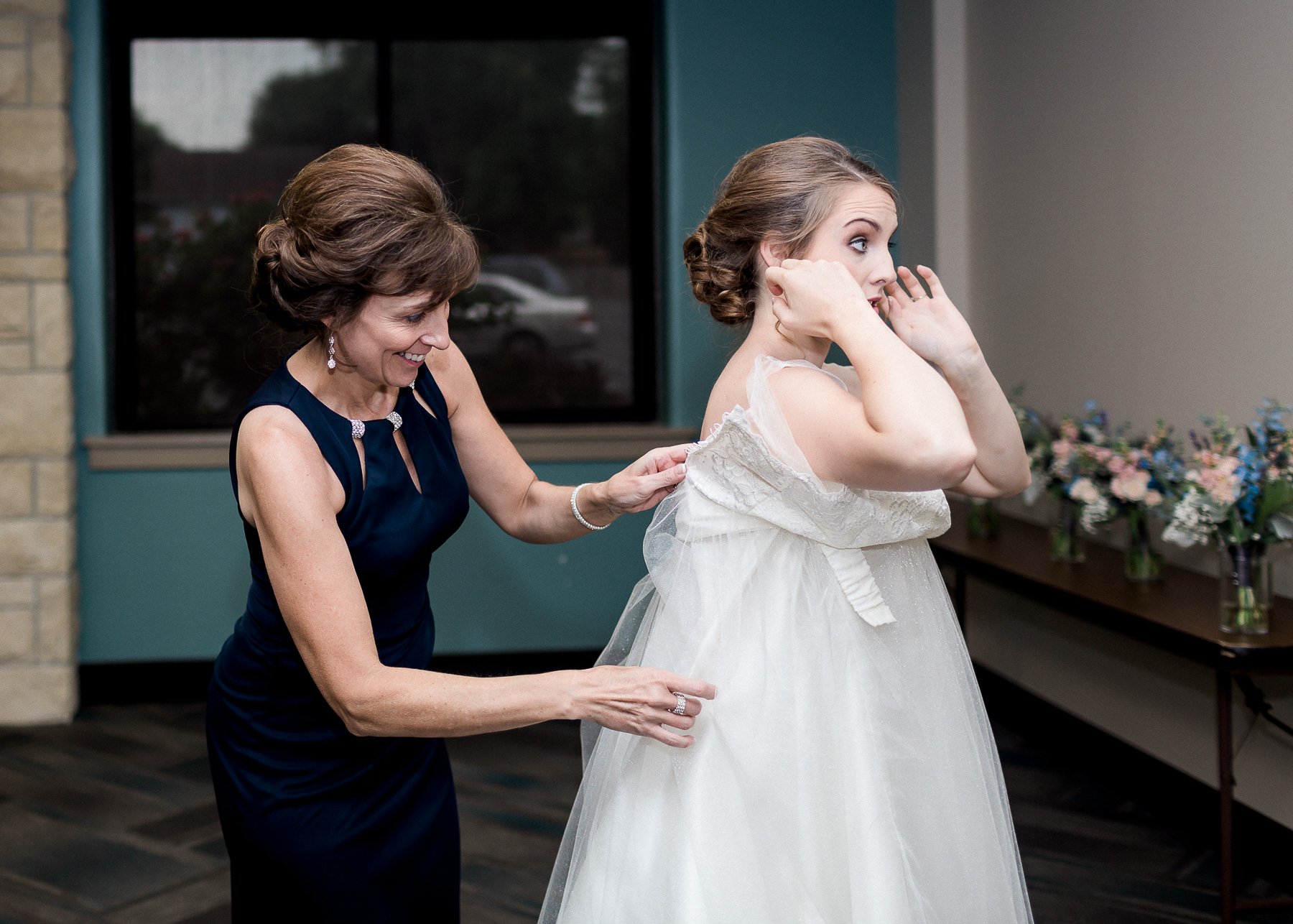 bride putting on wedding dress