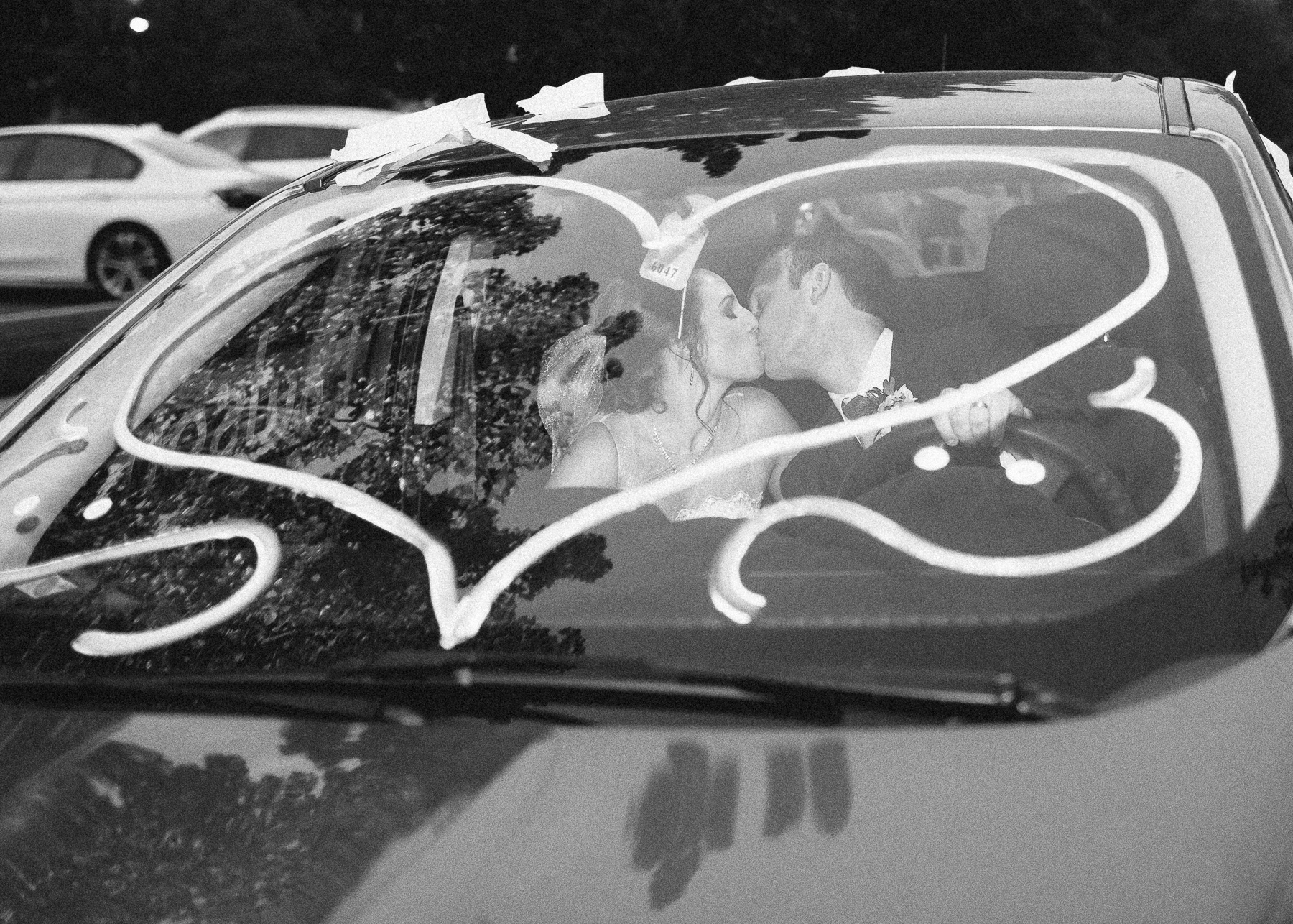 bride and groom in get-away car