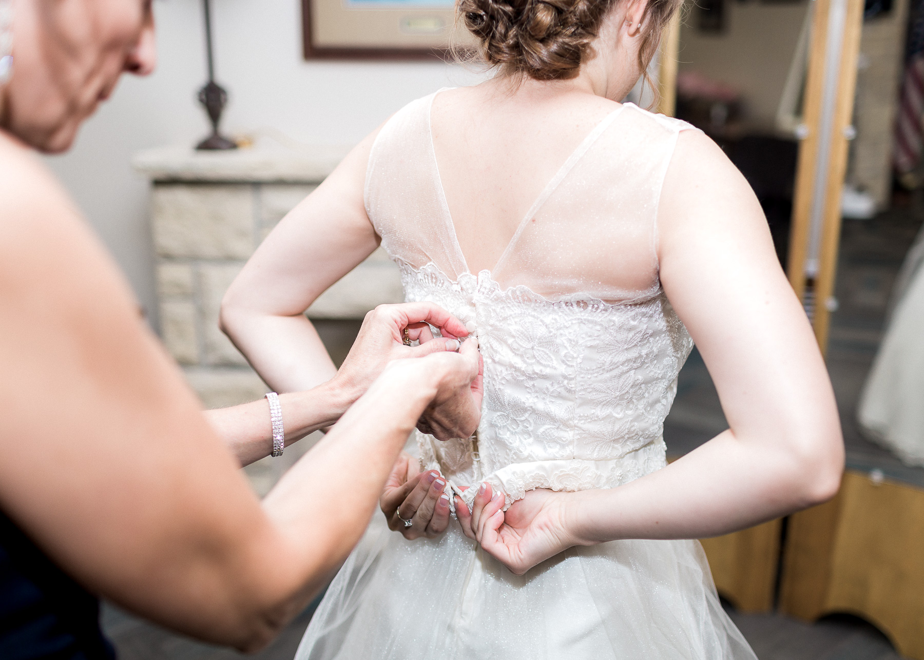 zipping up wedding dress