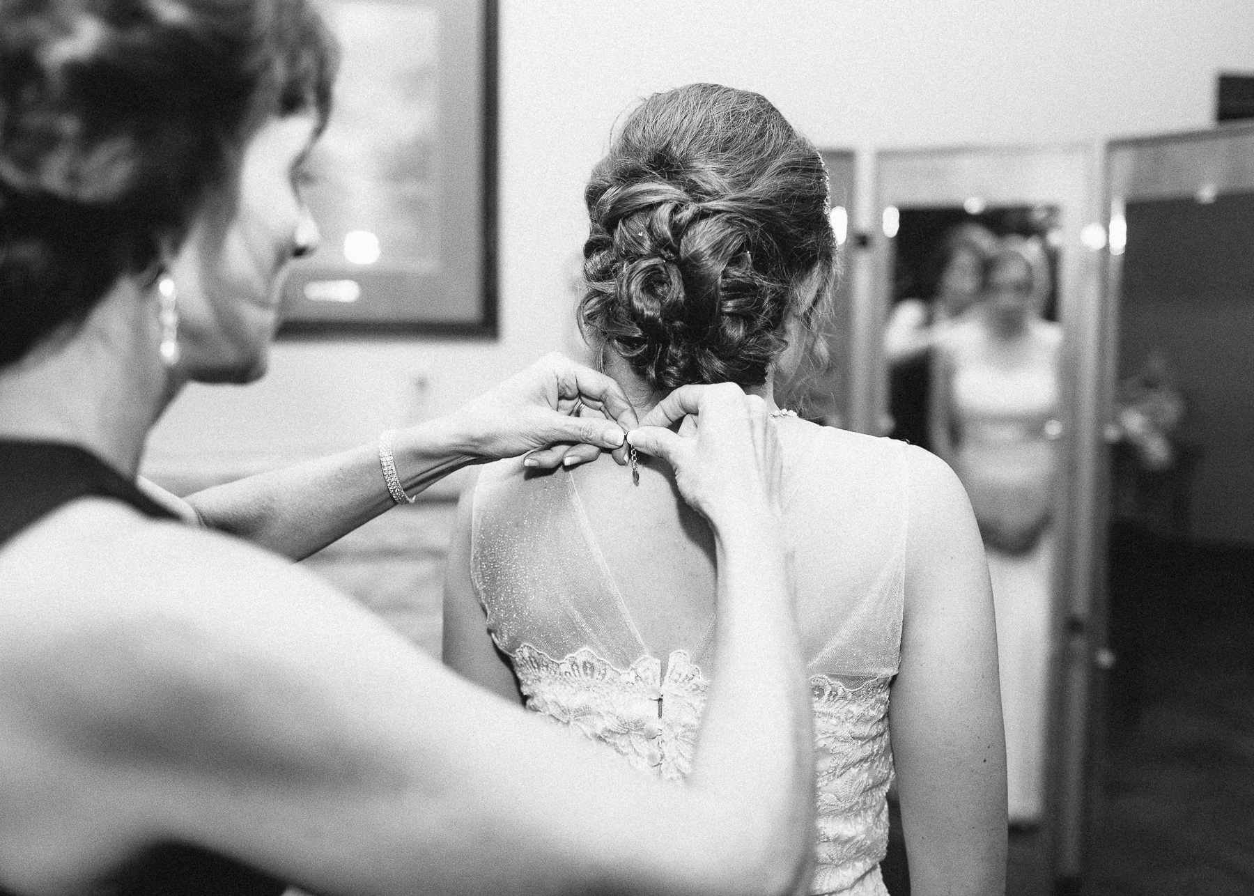 mother of bride putting on necklace