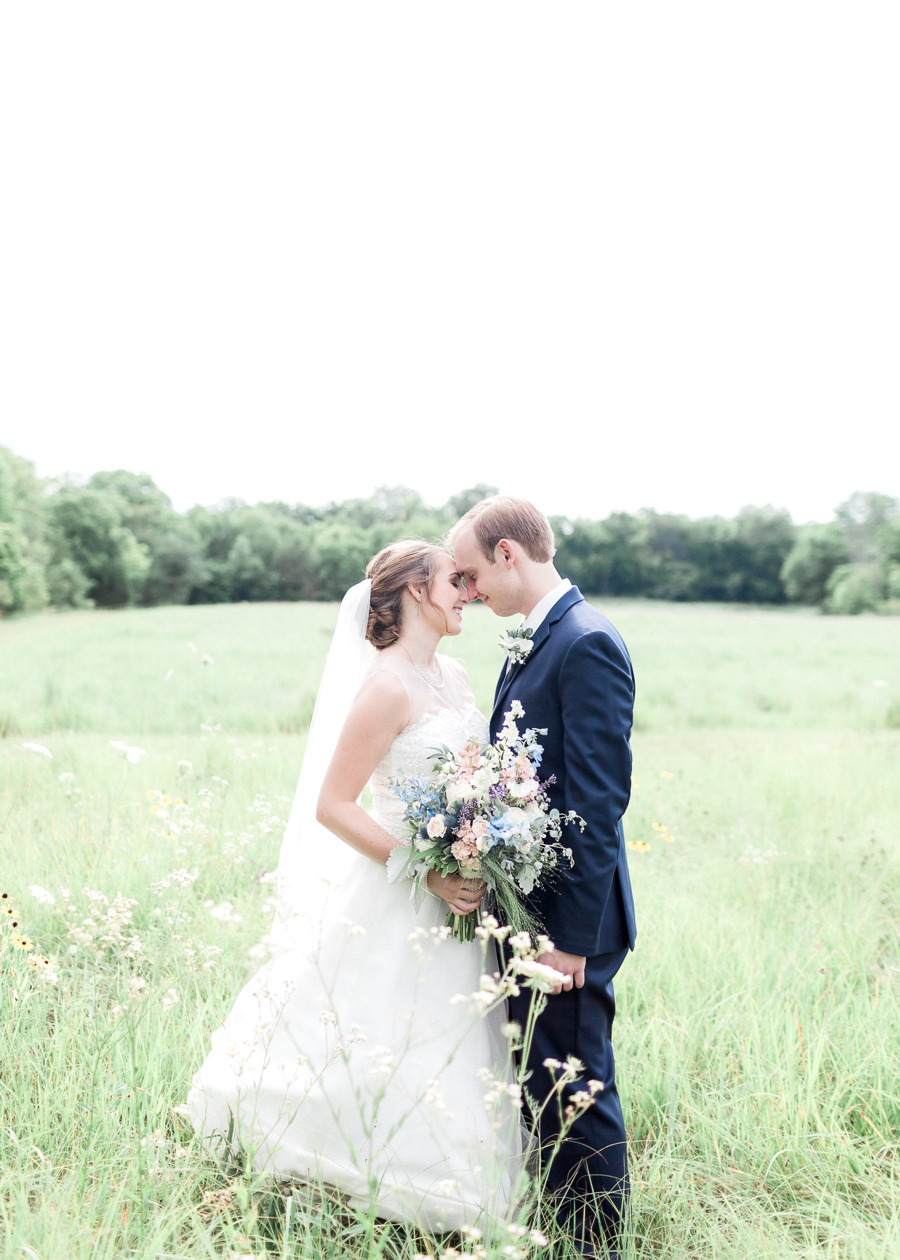 bride and groom in field