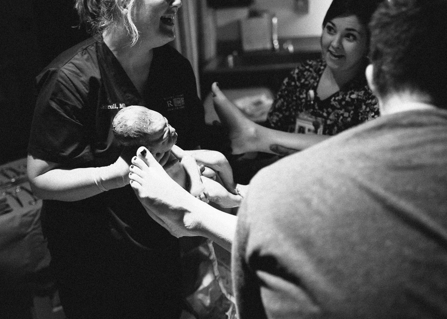 baby being held by doctor