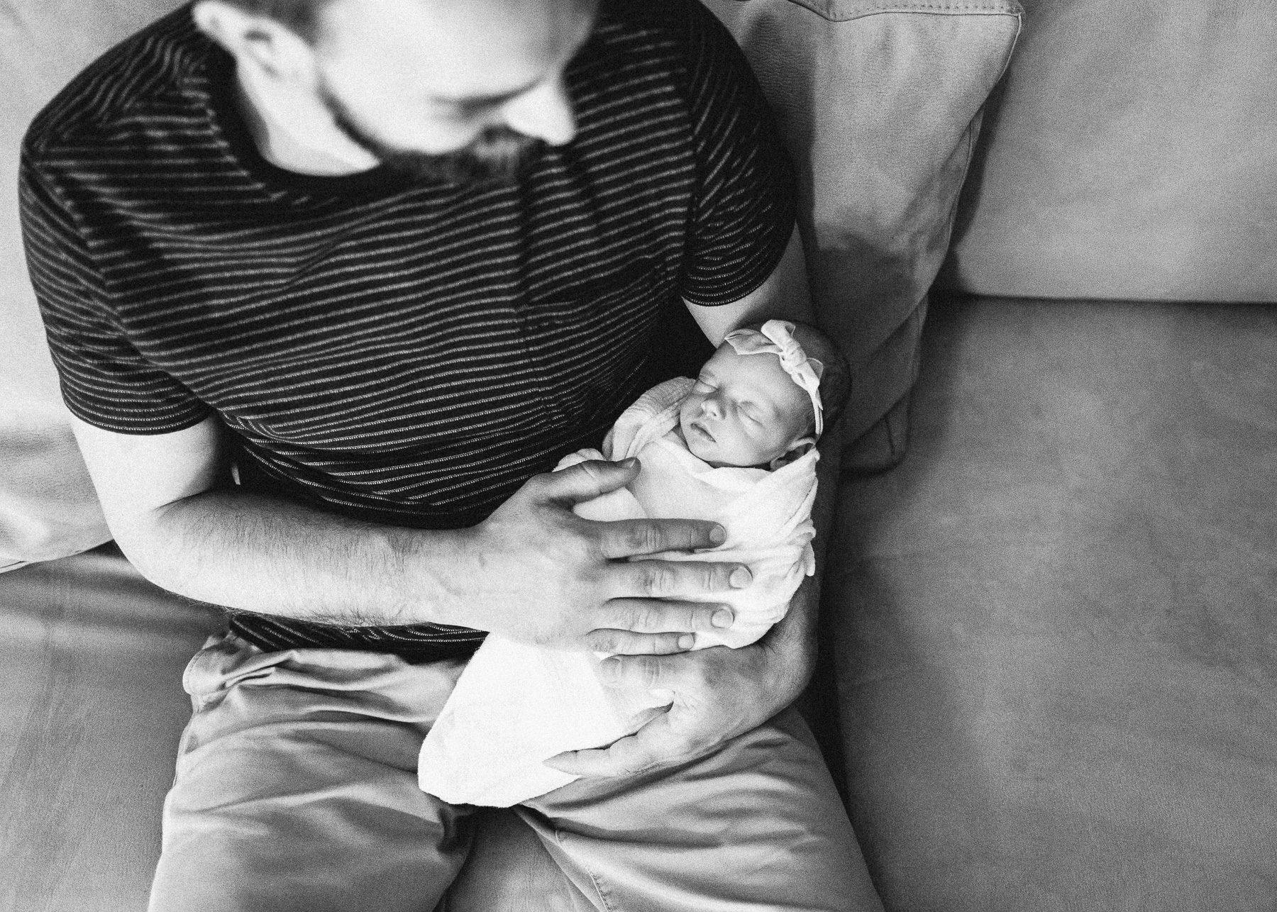 daddy holding baby while sitting