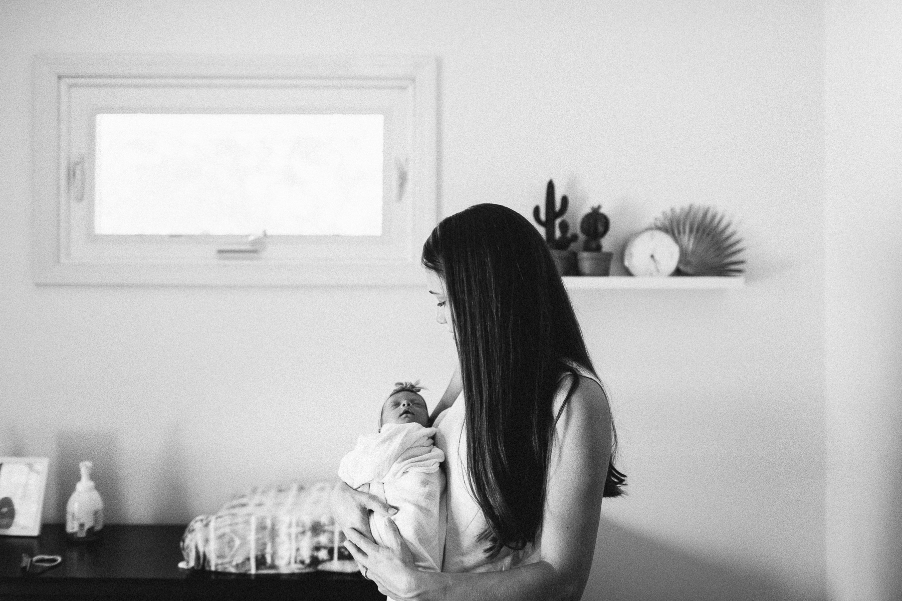 mama holding baby in nursery