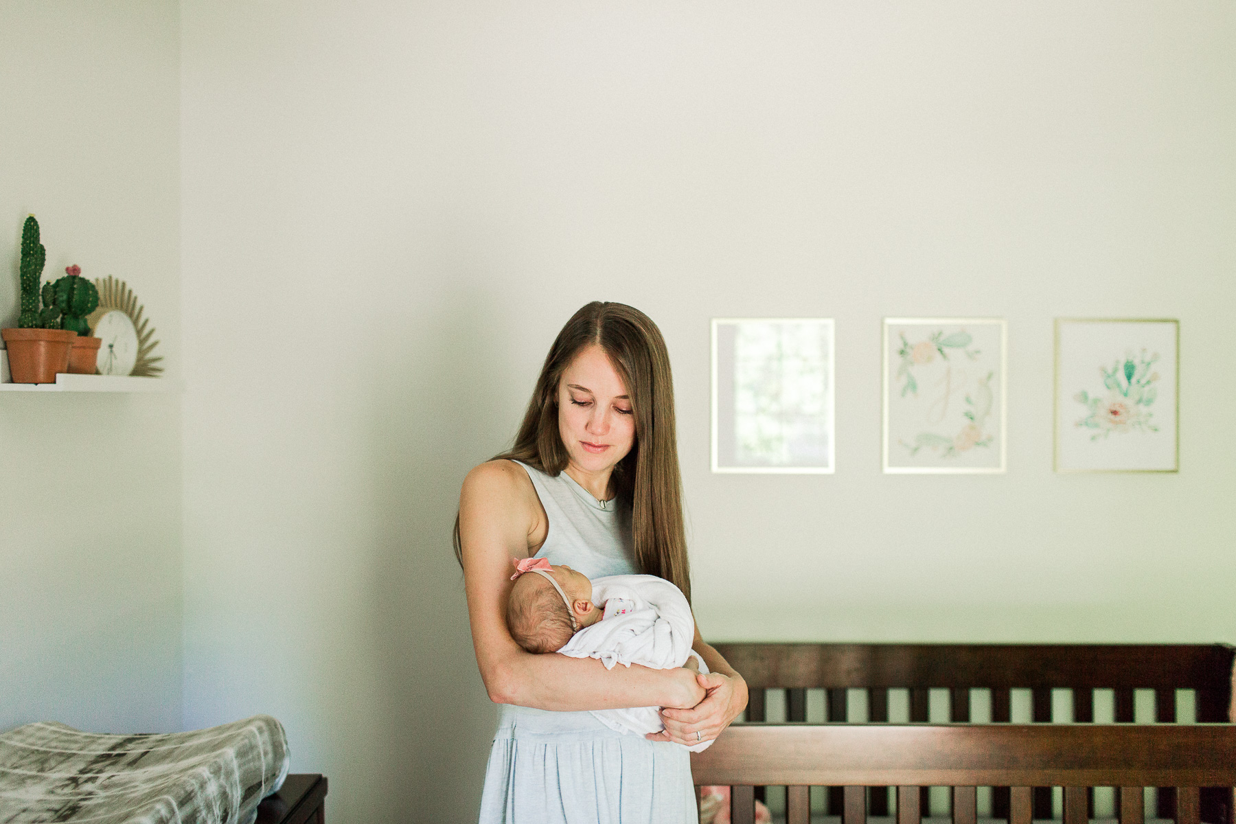 mama holding baby in nursery